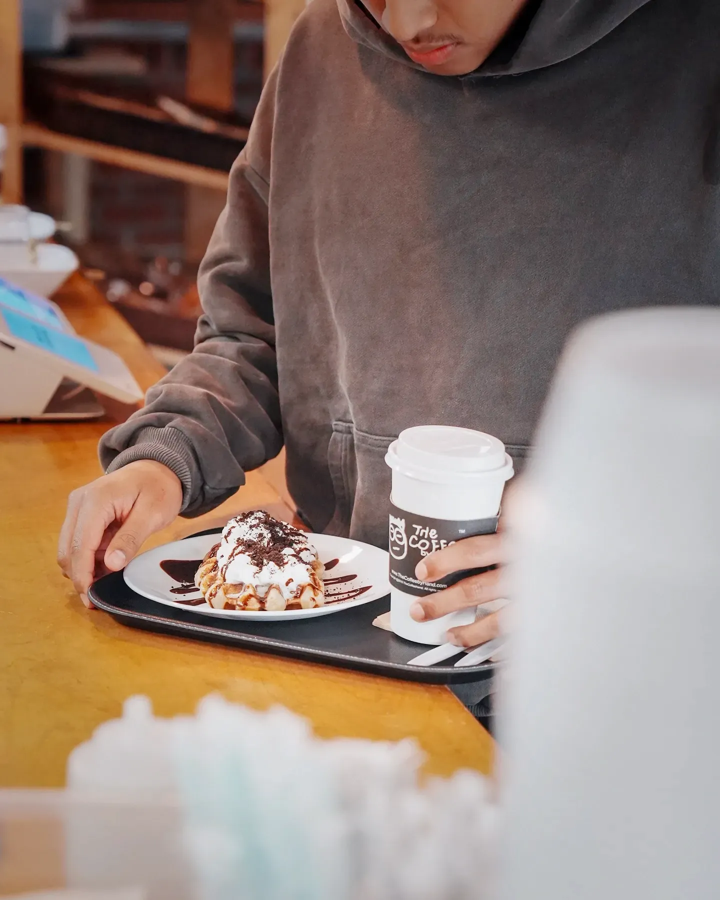 A croffle plate and a hot cup on a tray.