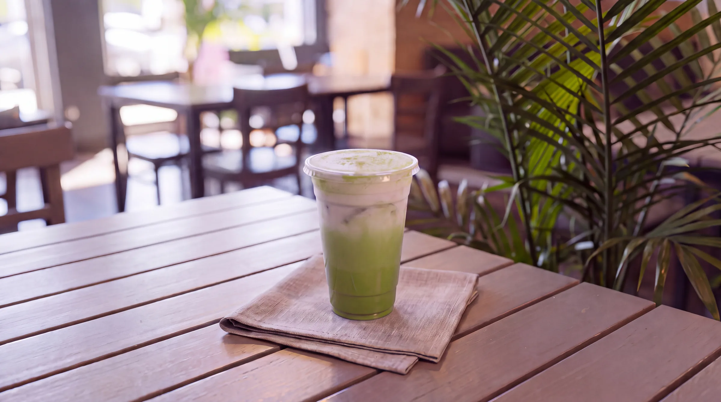 An iced green tea latte, matcha dusted.